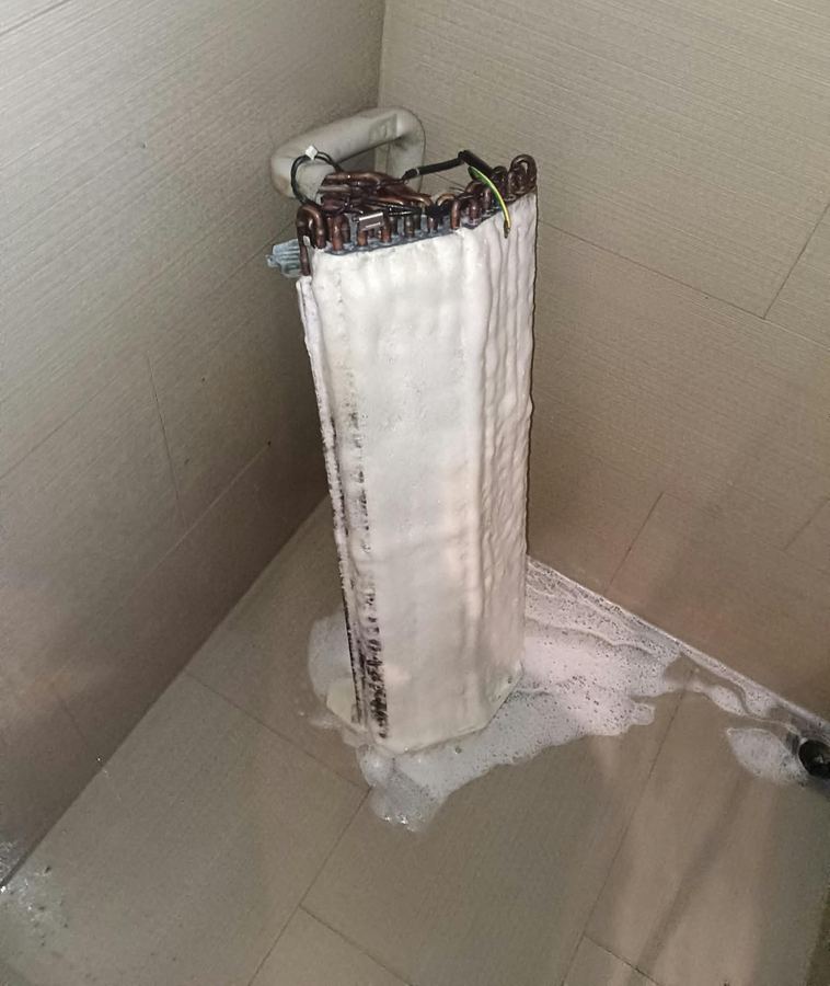 Aircon coil covered in chemical cleaning foam