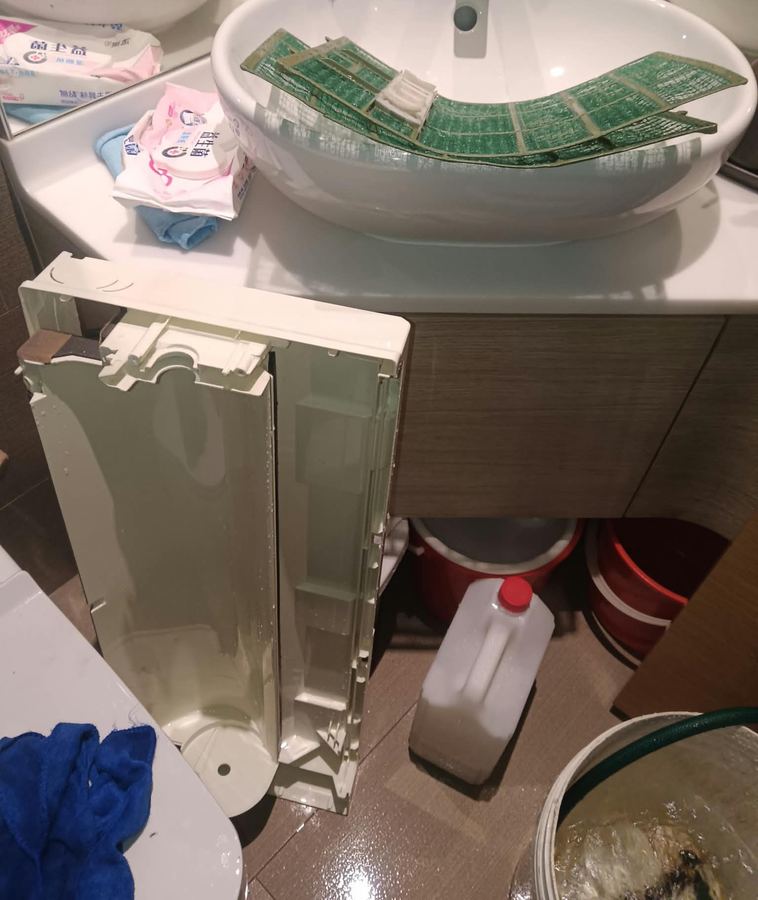 Aircon cover and parts being washed during an overhaul